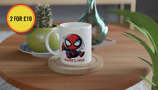 White mug with Spider-Man design on a wooden table with plants and decor.
